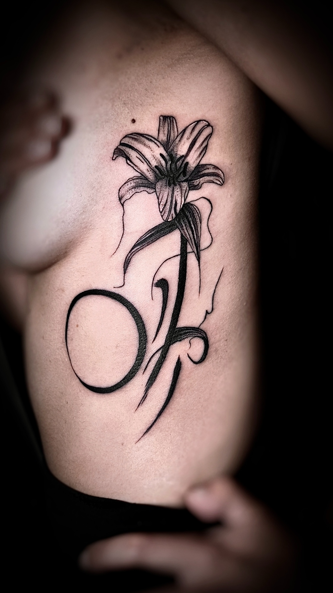 Lilie mit Buchstabe Tattoo